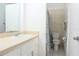 Bright bathroom featuring a neutral color scheme, vanity, sink, and toilet at 1017 Mabbette St, Kissimmee, FL 34741