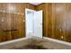 Bedroom showcasing wood paneled walls, carpeted floor and a door leading to another room at 1017 Mabbette St, Kissimmee, FL 34741