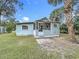 Charming single-story home with a screened-in porch and well-maintained front yard at 1017 Mabbette St, Kissimmee, FL 34741