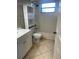 Bathroom featuring a shower, storage shelves, and a vanity at 2906 Fox Squirrel Dr # 41, Kissimmee, FL 34741