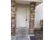 Home entrance featuring brick pillars and a white door with secure entry at 2906 Fox Squirrel Dr # 41, Kissimmee, FL 34741