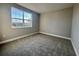 Bedroom with a large window, gray carpet, and neutral walls, creating a serene and inviting space at 3295 Roseville Dr, Apopka, FL 32712