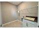 Bright laundry room features a utility sink and a wire rack at 3295 Roseville Dr, Apopka, FL 32712