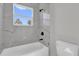 Bathroom features modern fixtures and a bathtub with elegant marble-style tiling at 4683 Sw 136Th St, Ocala, FL 34473
