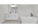 Bright bathroom featuring double vanity, a large mirror and a luxurious stand alone tub at 4683 Sw 136Th St, Ocala, FL 34473