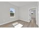 Bright bedroom boasts natural light and views, with neutral walls and wood-look flooring at 4683 Sw 136Th St, Ocala, FL 34473