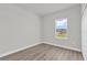 Bright bedroom with closet, wood-look floors, and neutral paint at 4683 Sw 136Th St, Ocala, FL 34473