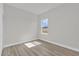 This bedroom gets good natural light and boasts wood-look flooring at 4683 Sw 136Th St, Ocala, FL 34473