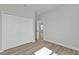 Bedroom featuring a large closet with double doors and wood-look flooring at 4683 Sw 136Th St, Ocala, FL 34473