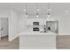 Bright kitchen features a large island, stainless steel appliances, white cabinets, and modern pendant lights at 4683 Sw 136Th St, Ocala, FL 34473