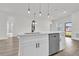 Bright kitchen features white cabinets, stainless steel dishwasher and stylish pendant lighting at 4683 Sw 136Th St, Ocala, FL 34473