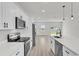Bright, modern kitchen featuring white cabinetry, stainless steel appliances, and a spacious quartz countertop island at 4683 Sw 136Th St, Ocala, FL 34473