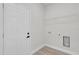 Clean laundry room with hookups, wire rack, and neutral paint at 4683 Sw 136Th St, Ocala, FL 34473