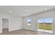 Bright living room with sliding glass doors and wood-look flooring at 4683 Sw 136Th St, Ocala, FL 34473