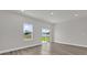 Open-concept living room featuring hardwood floors and sliding glass doors at 4683 Sw 136Th St, Ocala, FL 34473
