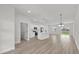 Bright living space featuring a modern white kitchen with barstool seating and an open floor plan at 4683 Sw 136Th St, Ocala, FL 34473