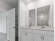 Double vanity bathroom with a large mirror at 5161 Springrise Dr, Saint Cloud, FL 34772