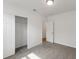 Bedroom with gray carpeting, mirrored closet doors, and an open door to another room at 5161 Springrise Dr, Saint Cloud, FL 34772