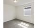 Bedroom with gray carpeting, window, and a ceiling light fixture at 5161 Springrise Dr, Saint Cloud, FL 34772