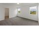 Bedroom with gray carpeting, window, and access to a bathroom at 5161 Springrise Dr, Saint Cloud, FL 34772