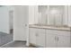 Bathroom boasts double vanity with granite countertop and tile flooring at 5186 Minneola Ln, Saint Cloud, FL 34772