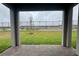 Back patio featuring a backyard with green grass, a young tree, and a dark metal fence at 3255 Roseville Dr, Apopka, FL 32712