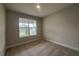 Bright bedroom featuring neutral carpet, freshly painted walls and a large window at 3255 Roseville Dr, Apopka, FL 32712