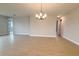 Spacious living room area with tile floors and contemporary chandelier lighting at 3255 Roseville Dr, Apopka, FL 32712