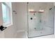 Glass enclosed shower featuring marble-like tile surround, modern fixtures and a built-in bench at 3255 Roseville Dr, Apopka, FL 32712