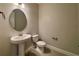 A neutral half bath features a pedestal sink with an oval mirror and a low-consumption toilet at 3263 Roseville Dr, Apopka, FL 32712