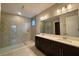 Modern bathroom with dual sinks, dark cabinets, and a glass-enclosed shower at 3263 Roseville Dr, Apopka, FL 32712