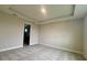 An airy bedroom features a tray ceiling, neutral paint, and plush gray carpeting at 3263 Roseville Dr, Apopka, FL 32712