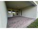 Back patio with brick pavers and a covered structure with sliding glass doors to the home at 3271 Roseville Dr, Apopka, FL 32712