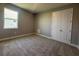 Neutral bedroom features carpeted floor, one window providing natural light, and double door closet at 3271 Roseville Dr, Apopka, FL 32712