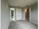 Bedroom featuring neutral-colored walls, carpet flooring, a window, and two doorways at 3271 Roseville Dr, Apopka, FL 32712