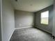 Bedroom featuring neutral-colored walls, carpet flooring, a window, and ample natural light at 3271 Roseville Dr, Apopka, FL 32712