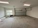 An empty two car garage with a concrete floor, window, and automatic garage door opener at 3271 Roseville Dr, Apopka, FL 32712