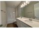 Bathroom featuring double sinks, white cabinets and an integrated shower and tub at 3279 Roseville Dr, Apopka, FL 32712