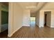 Hallway with wood-look floors leading to the backyard at 3279 Roseville Dr, Apopka, FL 32712