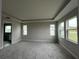 Bright main bedroom featuring a tray ceiling and large windows at 3279 Roseville Dr, Apopka, FL 32712