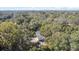 Aerial view of a house featuring backyard pool, surrounded by mature, shady trees at 1822 Se 8Th St, Ocala, FL 34471