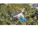 Aerial view of a private home featuring a pool, surrounded by mature trees at 1822 Se 8Th St, Ocala, FL 34471