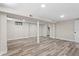 Bright basement with hardwood floors, support beams, and access to a closet at 1822 Se 8Th St, Ocala, FL 34471