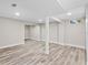 Renovated basement featuring hardwood floors, support beams, and recessed lighting at 1822 Se 8Th St, Ocala, FL 34471