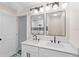 Well-lit bathroom featuring a double vanity, and a glass enclosed shower at 1822 Se 8Th St, Ocala, FL 34471