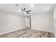Spacious bedroom featuring hardwood floors, a ceiling fan, and a view of the open door at 1822 Se 8Th St, Ocala, FL 34471