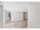 Hallway featuring wood-look flooring, leading to bathroom and living areas, freshly painted at 1822 Se 8Th St, Ocala, FL 34471