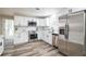 Modern kitchen with stainless steel appliances, white cabinetry, and stylish backsplash at 1822 Se 8Th St, Ocala, FL 34471