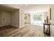 Spacious open-concept living space with door, lots of natural light, and view into kitchen at 1822 Se 8Th St, Ocala, FL 34471