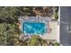 Aerial view of a large rectangular pool featuring a diving board and plenty of space for relaxing poolside at 1822 Se 8Th St, Ocala, FL 34471